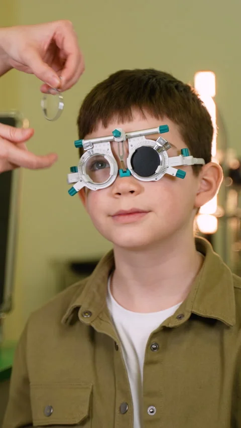 Young boy undergoing eye examination with trial frame Video stock 310812134