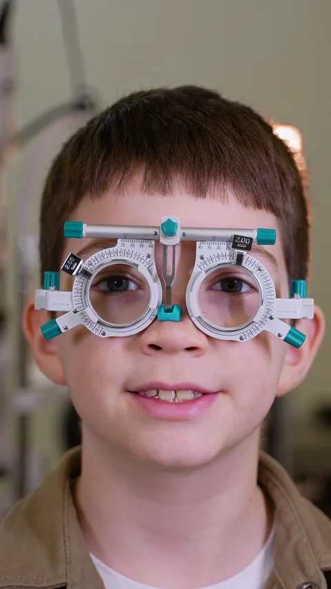 Young boy undergoing eye examination with trial frame Stock Footage 310812137