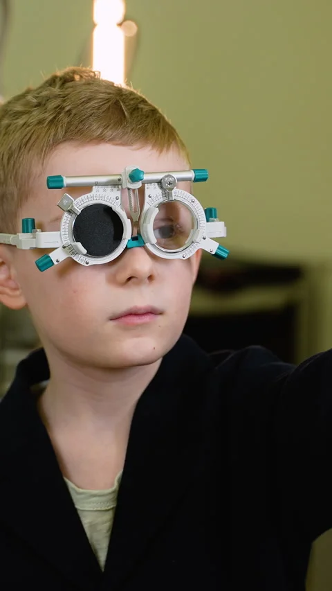 Young boy undergoing eye examination with trial frame Stock Footage 310812152