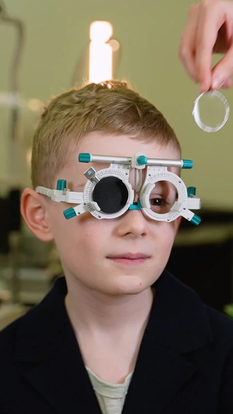 Young boy undergoing eye examination with trial frame Video stock 310812162