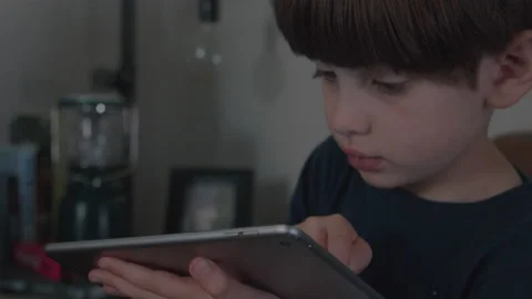Young Boy Uses an iPad Tablet During Scr... | Stock Video | Pond5