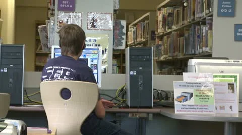 Young boy using a computer at the library Video stock 10774778