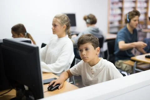 Young boy using computer in library Stock Photos