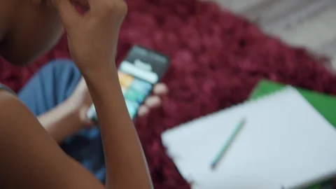 Young Boy Using Earbuds Headphones Listen to Music on Smartphone Stock Footage 129014282