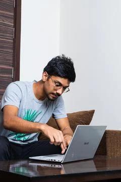 Young boy using his laptop for typing purpose Stock Photos