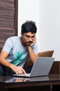 Young boy using his laptop for typing purpose Stock Photos
