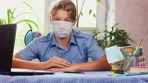 A young boy using a laptop computer sitting on top of a table Stock Footage 142813376