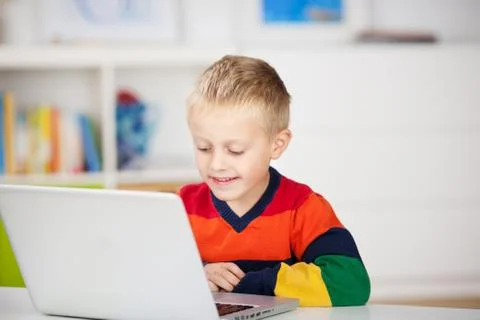 Young boy using a laptop Stock Photos