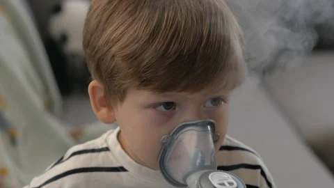 Young Boy Using Nebulizer at Home. Respiratory therapy Stock Footage 293588752
