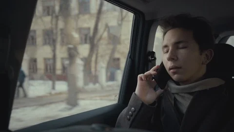 Young boy using smartphone during taxi ride in city Stock Footage 119290690
