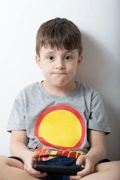 Young boy using a smartphone online gaming Stock-Fotos