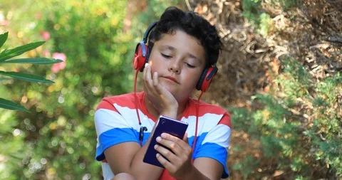 Young boy using smartphone at the oudoor 5 動画素材 92587275