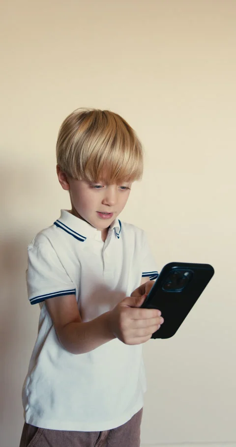 Young boy using smartphone playing mobile game Stock-Footage 346983299