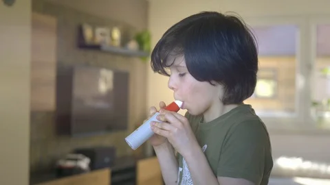 Young boy using Spirometer, Measuring Lung Capacity and Force Expiratory Volume. Video stock 128057089