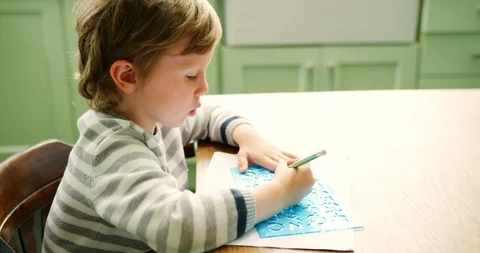 Young Boy Using Stencil To Learn How To Write Stock Footage 100043388