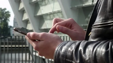 Young boy is using tablet PC on the street Stockbeeldmateriaal 55673755