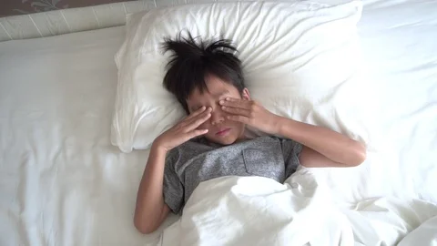 Young boy wake up on white bed Stock Footage 97111069