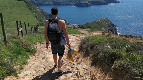 Young boy walking by the coast Stock Footage 130854591