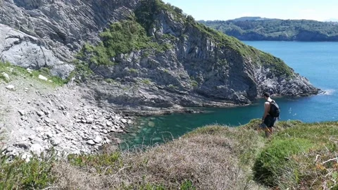 Young boy walking by the coast Stock Footage 130854632