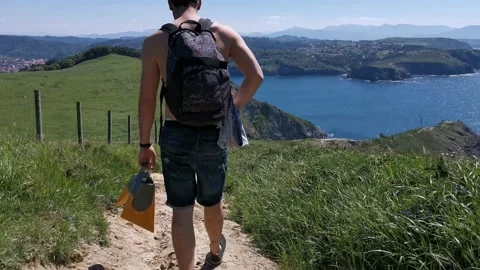 Young boy walking by the coast Stock Footage 130854825