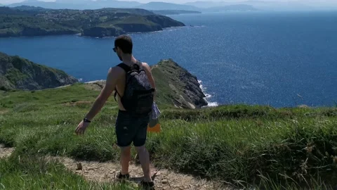 Young boy walking by the coast Stock Footage 130854855
