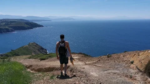 Young boy walking by the coast Stock Footage 130854885