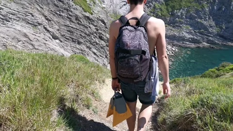 Young boy walking by the coast Stock Footage 130854939