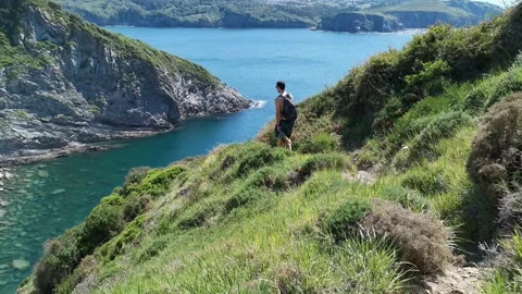 Young boy walking by the coast Stock Footage 130854970