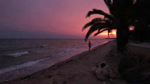 Young boy walking during pink sunset. 4K Video 스톡 동영상 164880925