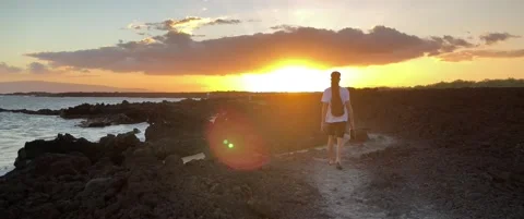 Young Boy Walking Towards Sunset in Slow Motion on a Lava Rock Hike Next 動画素材 158657372