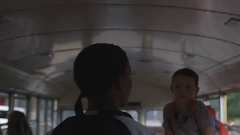 Young Boy Walks Down Isle of School Bus Stock Footage 208712868
