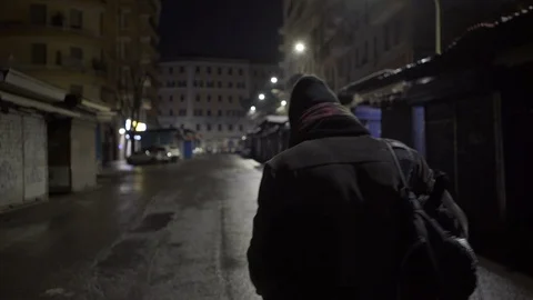 A young boy walks at night in Rome's suburbs Stock Footage 101299012