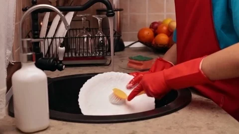 Young boy washing dishes in the kitchen Stock Footage 80241764