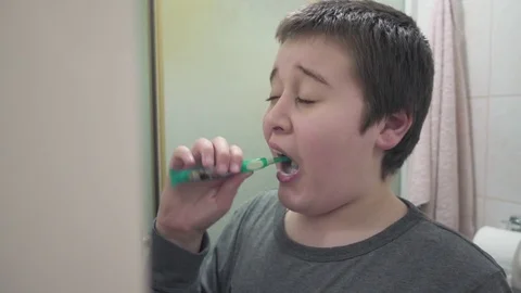 Young boy washing teeth Stock Footage 73479976
