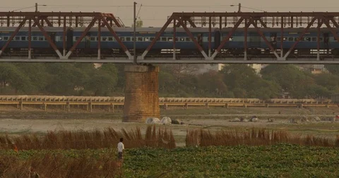 A young boy watches the train go by near the Taj Mahal Stock Footage 72996905