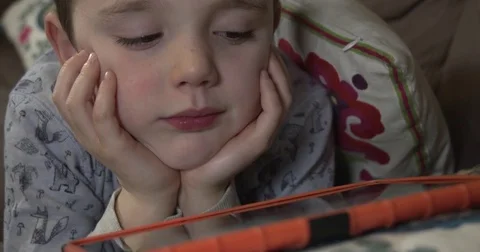 Young boy watching something on his tablet computer Stock-Footage 71318106