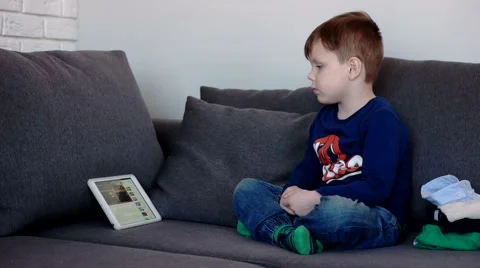 Young Boy Watching Videos on a Tablet Computer, Side View Vídeo Stock 62499470