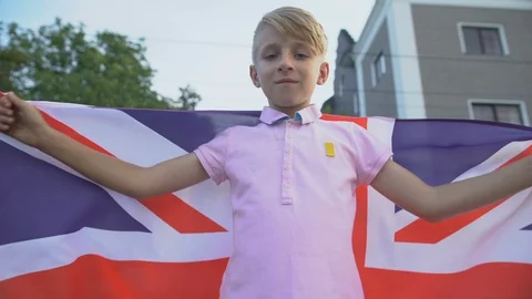 Young boy waving British flag, celebrating national holiday outdoor, patriotism Vídeos de archivo 117209059