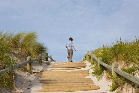 Young boy on wooden path Foto stock