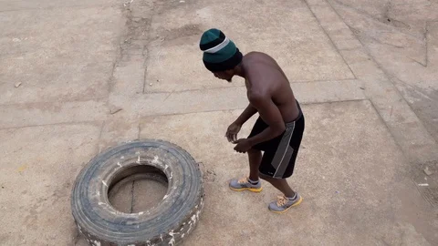 Young boy work out by lifting tire Stock Footage 115713018