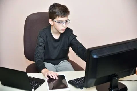 Young boy working on the computers Stock Photos