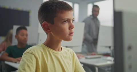 Young Boy Working on Creative Project on Computer, Practicing Digital Skills and Stock Footage 316296462