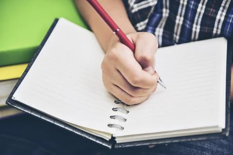 A young boy writing on notebook diary Stock-Fotos