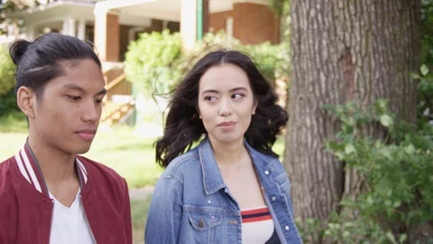 Young boyfriend lovingly puts arm around girlfriend and embraces her. - Slow Stock Footage 125219222