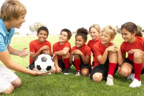 Young Boys And Girls In Football Team  With Coach Stock Photos