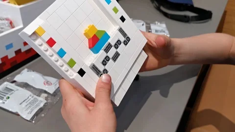 Young boys hand in inserting minifigure that corresponds to menu elements Stock Footage 113361312