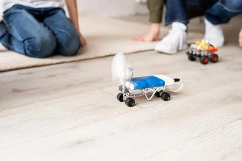 Young boys having fun constructing robot cars at the workshop Stock Photos