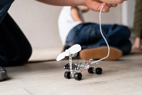 Young boys having fun constructing robot cars at the workshop Stock Photos