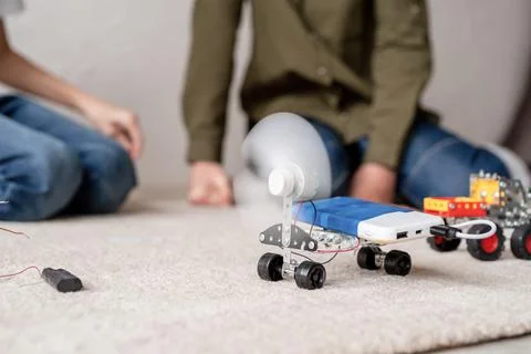 Young boys having fun constructing robot cars at the workshop Stock Photos