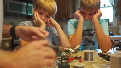 Young boys learning how to solder wires in electronics Stock Footage 160346708